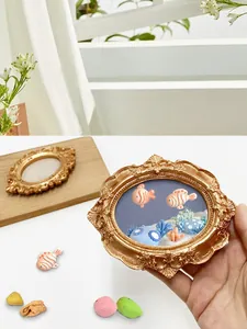Macro detail of a miniature vintage gold frame with 3D handmade fish and coral landscape