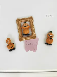 Macro shot of Halloween pumpkin magnets and ornaments in a retro golden frame set