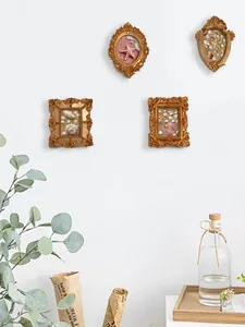 Close-up of vintage gold embossed frames with starfish and seashell coastal decor