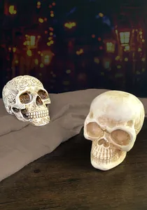 Detail view of two resin skulls with Celtic patterns and weathered textures for Halloween