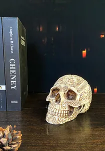 Detailed close-up of intricate Nordic floral carvings on a vintage resin skull figurine