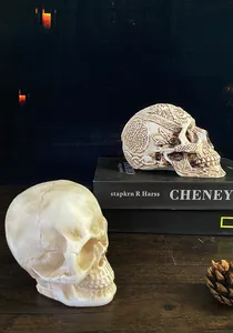 Close-up of gothic resin skulls with intricate Celtic knot patterns on vintage wood
