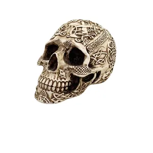 Gothic resin skull ornament featuring intricate Celtic knot carvings in ivory white finish