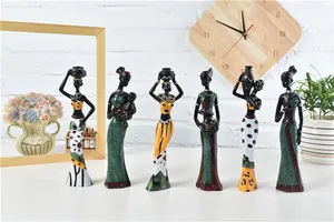 Detail shot of six African tribal resin figurines with hand-painted patterns on a wood table
