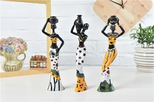 Detailed view of African resin figurines with vibrant folk patterns on a white shelf