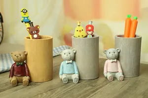 Three creative cartoon bear pencil holders in brown, blue, and pink resin with wood texture