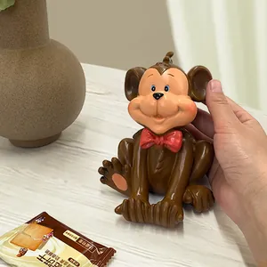 Detail of creative monkey phone holder accessory on a desktop in a cozy home setting