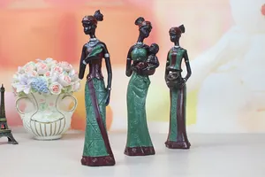 Detailed set of three resin African tribal figurines in traditional ethnic attire