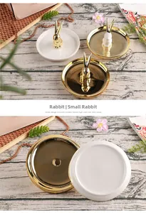 Detail of golden ceramic rabbit jewelry tray showing polished base and elegant design