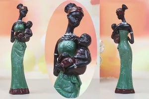 Detailed view of an exotic resin African mother and child statue with green relief dress