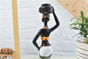 Detailed close-up of African woman figurine with a brown pot and golden neck jewelry
