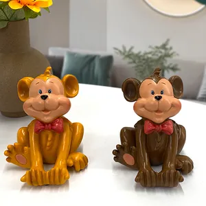 Pair of cute resin monkey phone stands in yellow and brown with red bow ties