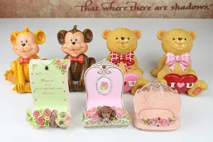 Detailed resin monkey and bear phone holders with vintage rose and ribbon accents