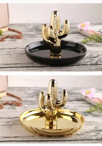 Detail view of gold and black cactus ceramic jewelry trays with metallic finish