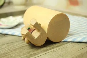 Close-up of a bear figurine pushing a faux wood pen holder on a blue checkered cloth