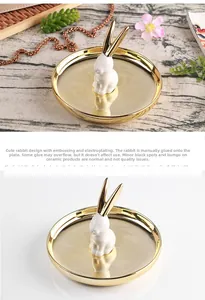 Detail of golden ceramic jewelry tray with a white rabbit and electroplated finish