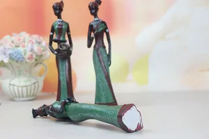 Macro detail of African resin statues with tribal jewelry and colorful ethnic clothing