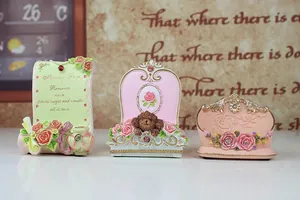 Detailed view of vintage resin figurines featuring floral motifs and engraved patterns