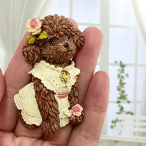 Cute brown resin poodle fridge magnet with white lace dress and pink rose details