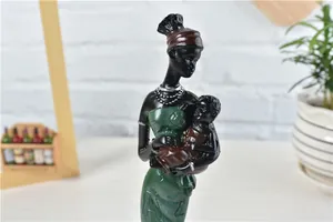Detailed resin figurine of African mother and child in traditional ethnic attire
