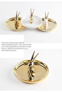 Close-up of ceramic jewelry tray with gold plated rabbit figurine and glossy finish