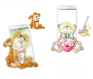Detail view of monkey and bear desktop phone stands showing the supporting design