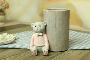 Close-up of a resin cartoon bear pencil holder with wood texture and vintage details