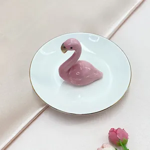 Close-up of pink flamingo ceramic jewelry tray with elegant gold rimmed detail
