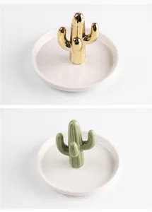 Detailed view of Nordic ceramic jewelry trays featuring gold and green cactus ring holders