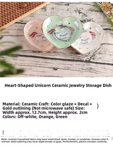 Detail showing heart-shaped ceramic unicorn jewelry trays with gold rim and vivid colors
