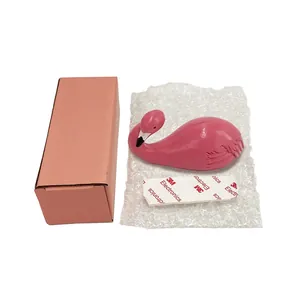 Pink flamingo wall hook with 3M adhesive tape and packaging box on bubble wrap