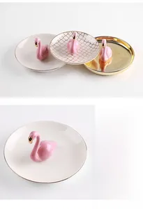 Detail of flamingo ceramic jewelry dish with gold edges for rings and necklaces