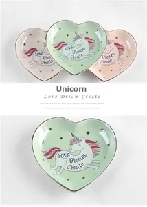 Detail of heart ceramic jewelry dish with unicorn design and gold rim finish