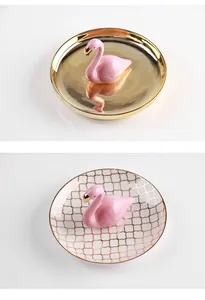 Detail of pink flamingo ceramic jewelry trays with gold mirror and plaid patterns