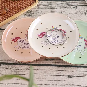 Detail of ceramic unicorn jewelry tray with gold rim and Love Dream Create slogan