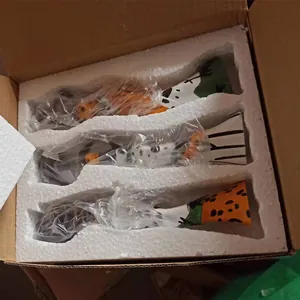 Detailed top view of African resin figurines packed securely in foam inside a shipping box