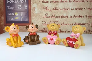 Detailed view of monkey and teddy bear phone holders set on a creative wooden desk display