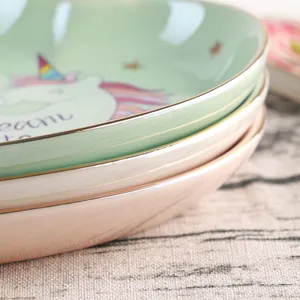 Ceramic unicorn heart jewelry tray with gold trim and Dream text in stacked pastel colors