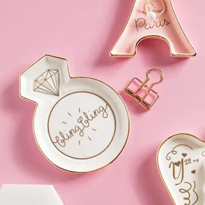 Nordic ceramic jewelry dish set with gold trim featuring ring, tower, and heart shapes