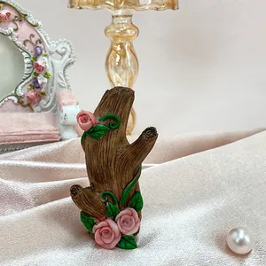Creative resin tree branch wall hook featuring pink roses and rustic wood texture
