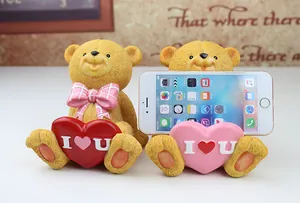 Detail showing two bear resin phone stands with I Love U hearts for desk decor