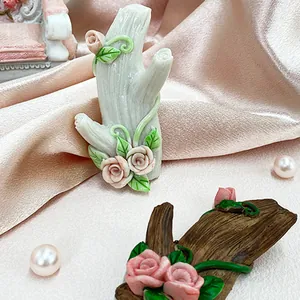 Detail of tree branch wall hook featuring realistic texture with pink resin roses