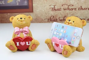 Macro detail of bear phone stand with heart showing resin texture and smartphone support