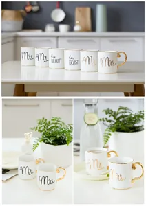 Detail of Mr and Mrs ceramic mugs with gold rims and elegant cursive branding text