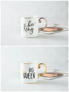 Detail of couple ceramic mugs showing gold His Queen and silver Her King crowns