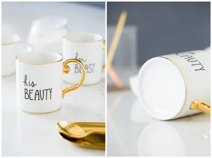 Detail of his BEAUTY and her BEAST ceramic mugs with gold plated handles and matching spoons