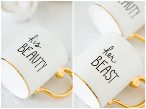 Detail of his BEAUTY and her BEAST gold-rimmed ceramic mugs with elegant vintage handles