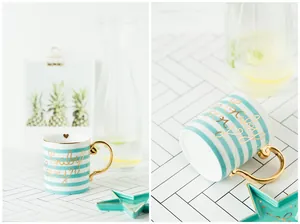 Detailed close-up of blue striped ceramic mug with gold handle and star-shaped saucer