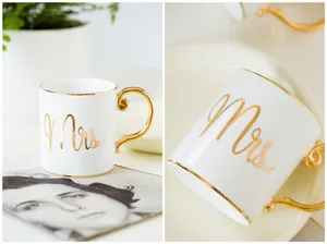 Close-up of Mrs engraved text on ceramic mug with elegant gold rim and curved handle