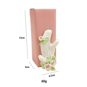 Detailed view of white resin tree branch hook with pink roses and size dimensions